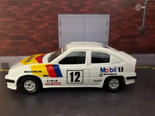 Diecast rally car model, white with yellow decals and number 12 on side
