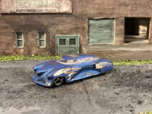 Weathered blue 1/64 diecast custom project car with flame-style graphics