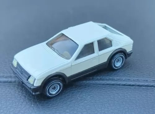 Vintage diecast sedan car in light blue with black wheels, side view