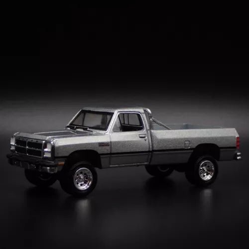 Gray 1:64 diecast pickup truck model with chrome grille and open cabin