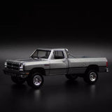 Gray 1:64 diecast pickup truck model with chrome grille and open cabin