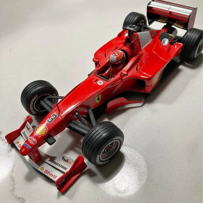 Michael Schumacher Formula 1 diecast racing car, red with black tires and front wing