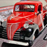 Red vintage pickup truck die-cast model, front view with chrome grille