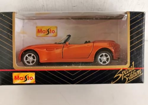 Orange diecast convertible model car with wheels, in retail packaging