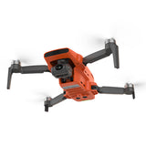 Orange quadcopter drone with camera gimbal and foldable propeller arms