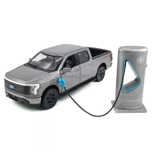 Gray diecast pickup truck model with front grille detail and EV charging stand with cable