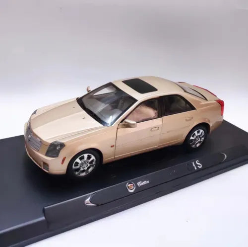 1/18 scale diecast car model of a gold/beige Cadillac CTS sedan on black display base
