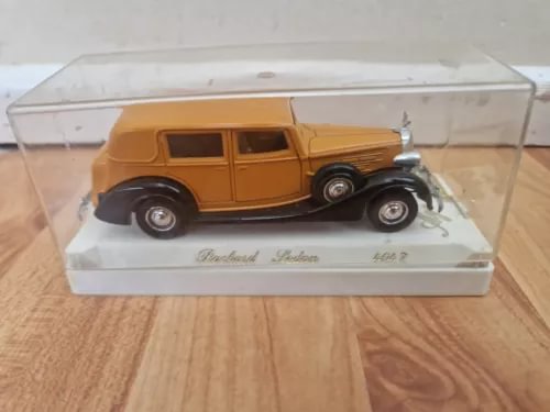 Brown classic diecast sedan in clear display case, chrome grille and bumper
