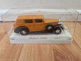 Brown classic diecast sedan in clear display case, chrome grille and bumper