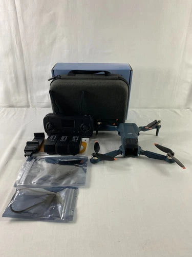 Foldable quadcopter drone with remote controller, carry case, and accessory bags