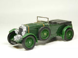 Green vintage diecast model car with open top, chrome grille and headlights