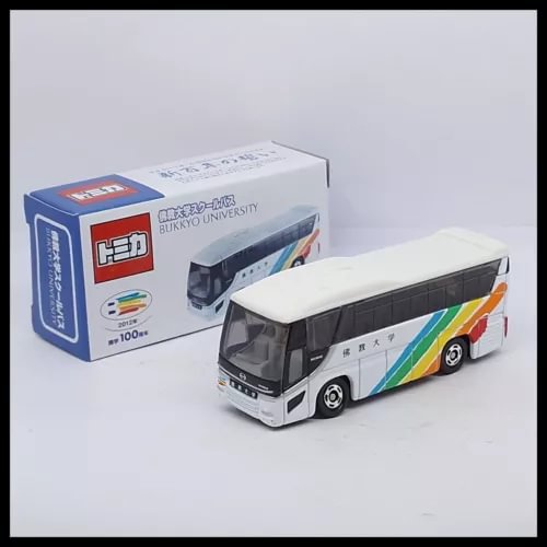 Diecast bus model in white with multicolor stripe, front three-quarter view.