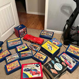 Vintage diecast car collection with multiple boxed cars and a red car model