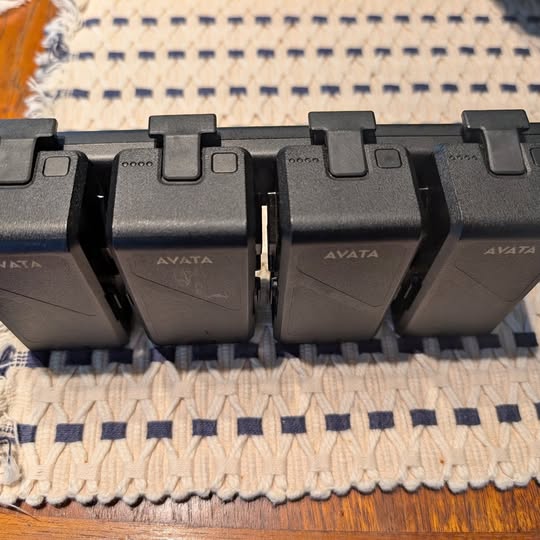 Black AVATA charging dock with three battery bays