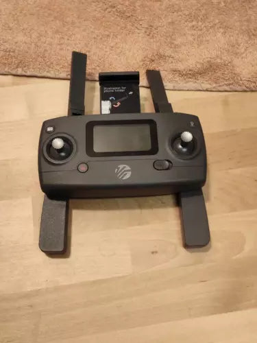 Drone controller with LCD screen, two joysticks, and two antennas
