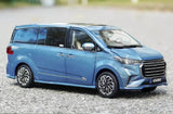 Blue 1/18 scale diecast MPV toy car with chrome grille, front three-quarter view