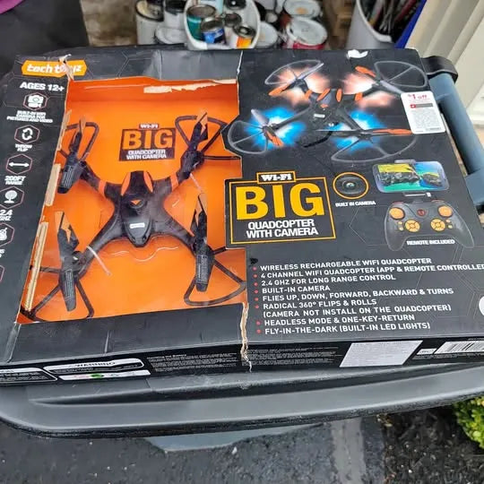 Boxed quadcopter drone kit with controller, wings and camera graphics on package