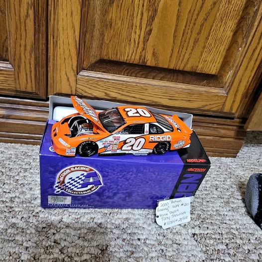 Orange and black diecast race car #20 with RIDGID decals on blue box