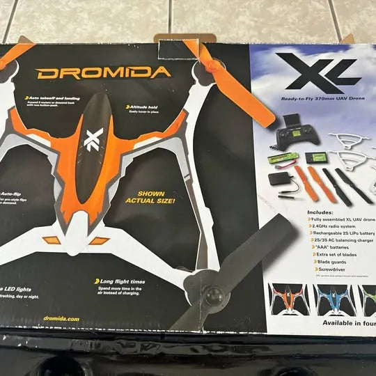 UAV drone kit box with printed Dromida XL drone and accessory parts, orange and black