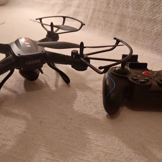 Quadcopter drone with propellers and remote controller