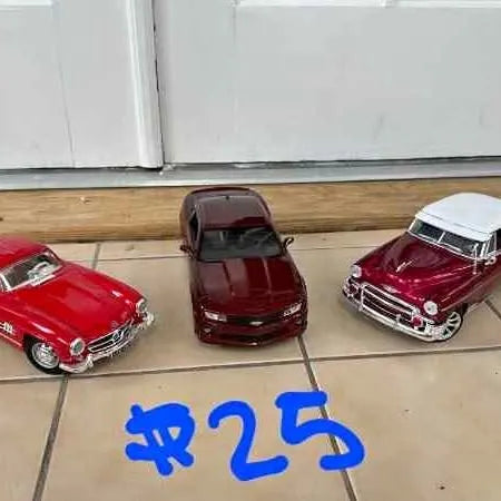 Three 1:18 diecast cars, red and burgundy, with chrome bumpers