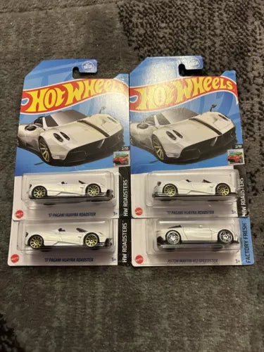 White 1:64 diecast roadster car in Hot Wheels blister pack, two-pack view