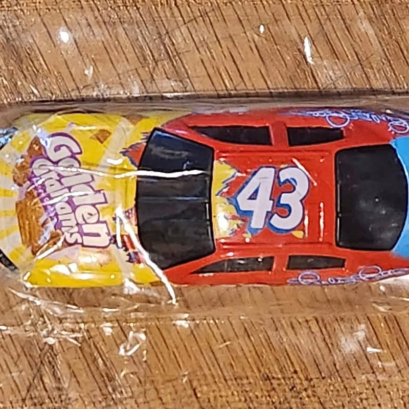 Red #43 diecast race car with black window panels and rear spoiler detail