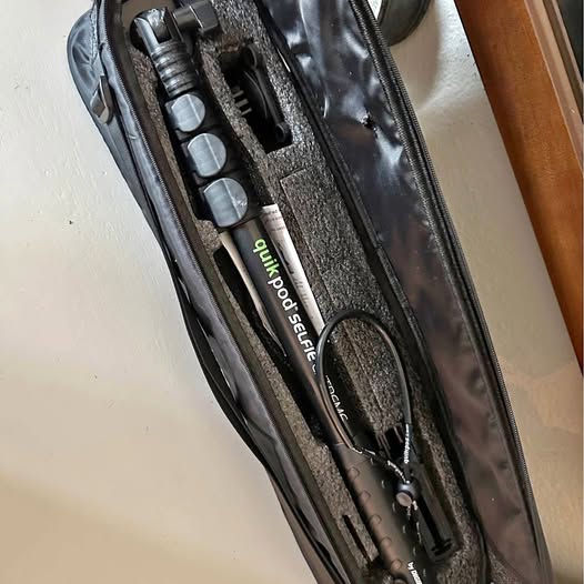 Black zippered drone carrying case interior with tool compartments and accessories