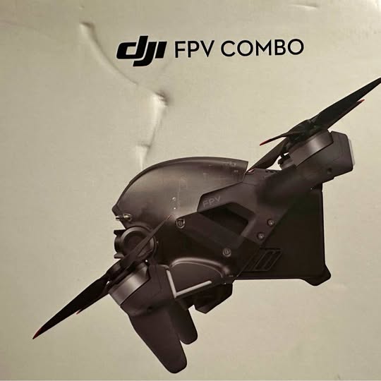 DJI FPV drone with dark body and four propellers, compact quadcopter
