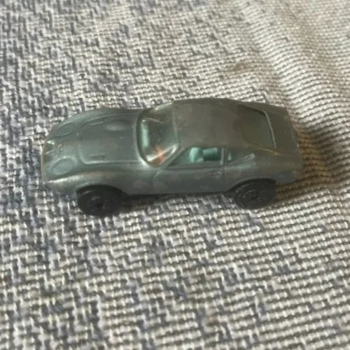 Dark green two-door diecast car model with detailed front and wheel