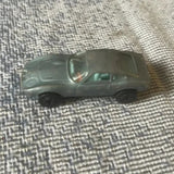 Dark green two-door diecast car model with detailed front and wheel