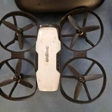 White mini drone quadcopter with four propellers and compact body