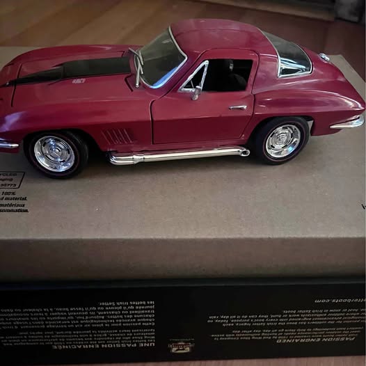 Maroon 1967 Chevrolet Corvette Sting Ray diecast car, side view with chrome details