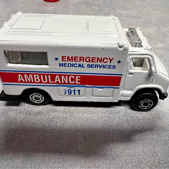 White diecast ambulance model with Emergency Medical Services and 911 markings