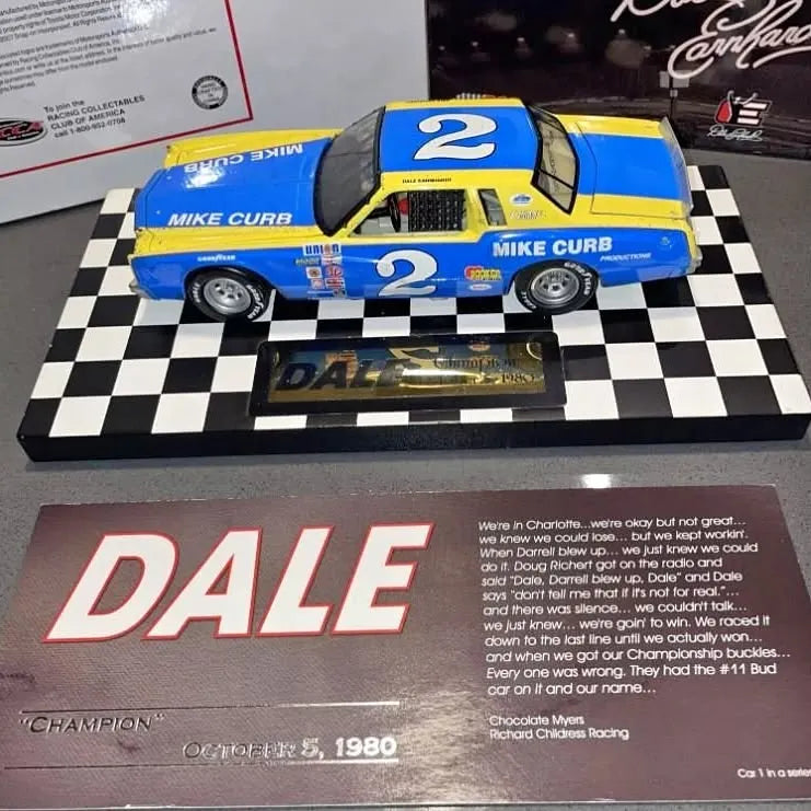 Blue NASCAR diecast race car #2 on checkered display base with “DALE” sign