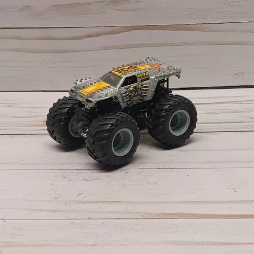 Gray and yellow diecast monster truck, four oversized wheels, 1:64 scale