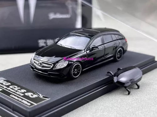 Black die-cast wagon model car with front-left view on display base