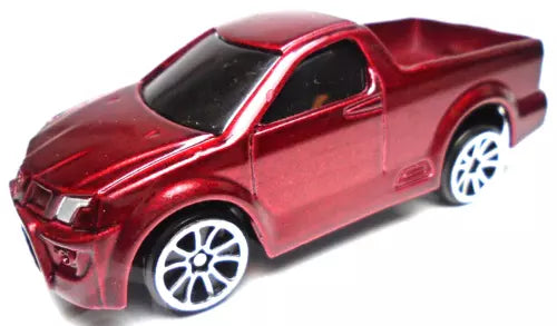 Red diecast pickup truck with silver rims, black windows, side view