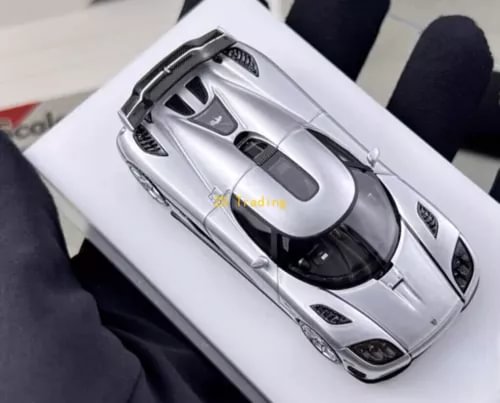 Silver 1:64 diecast sports car model with detailed front grille and headlights
