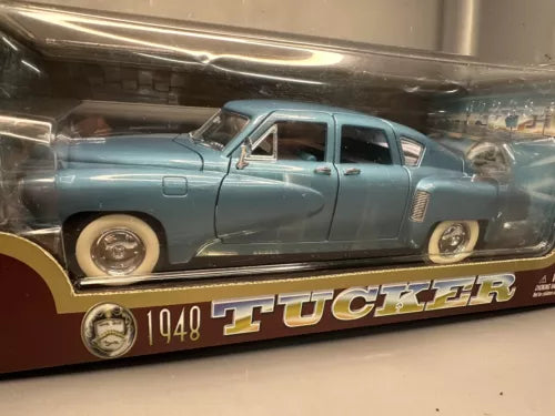 Blue die-cast model car, front-side view with chrome bumper and Tucker 1948 plate