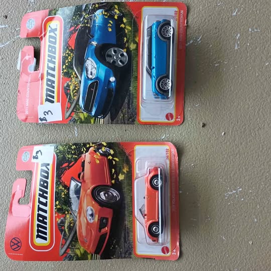 Blister-pack diecast cars, blue and red race cars in red card packaging