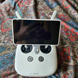 White drone controller with display and control buttons