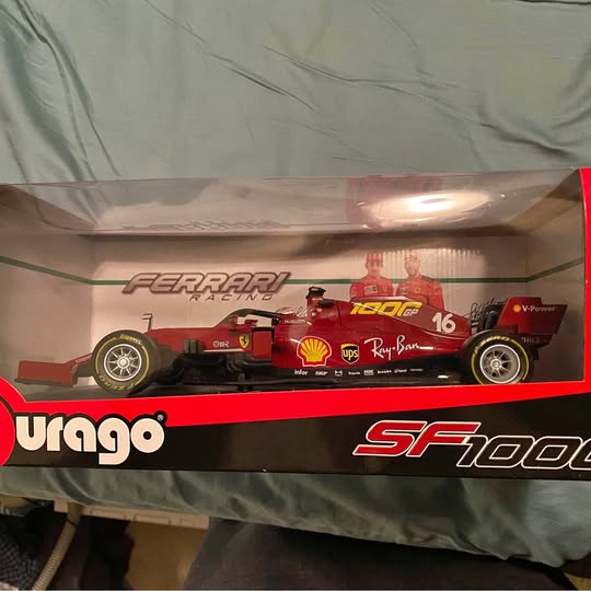Boxed 1/10 scale red Ferrari racing diecast car model with sponsor decals