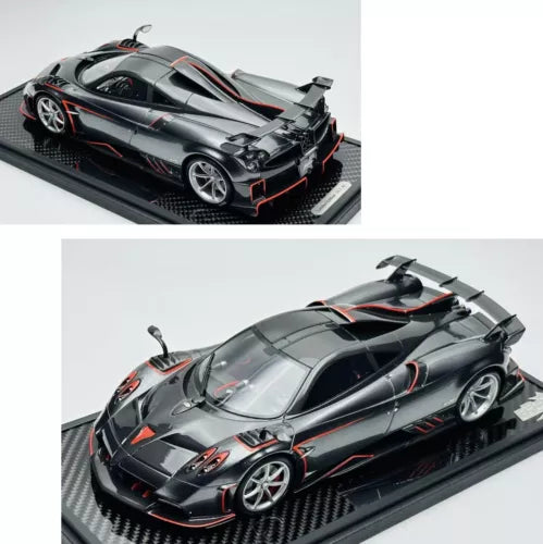 Dark grey diecast model car with carbon-fiber base, silver wheels and rear wing