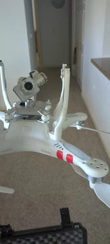 White quadcopter drone with camera gimbal and front propellers