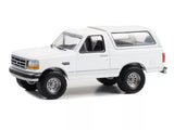 White diecast 1993 Ford Bronco XLT model SUV, side view, Greenlight 1:64