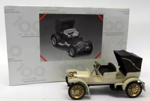 Vintage diecast toy car, cream body with black seats and gold wheels
