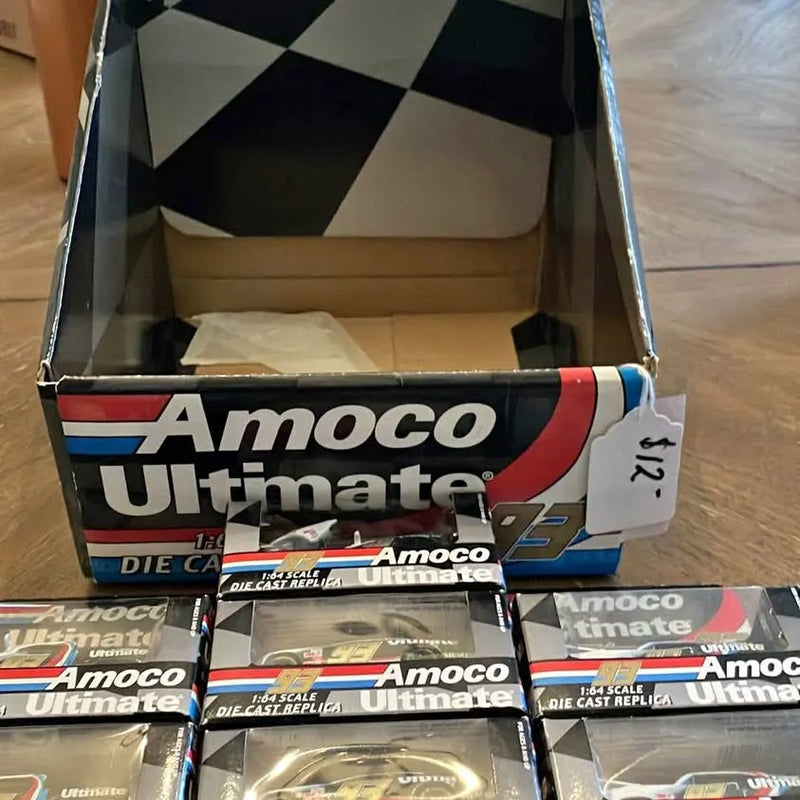Amoco Ultimate diecast car replica in retail box, stacked with multiple packages