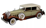 1930 Packard Brewster diecast sedan model, olive green with cream roof and whitewall tires