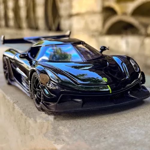 Diecast sports racing car model, black with blue accents, front 3/4 view